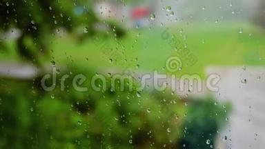 <strong>雨水</strong>在多汁的绿色背景下从<strong>玻璃</strong>表面流下。 关上<strong>玻璃</strong>上的水滴